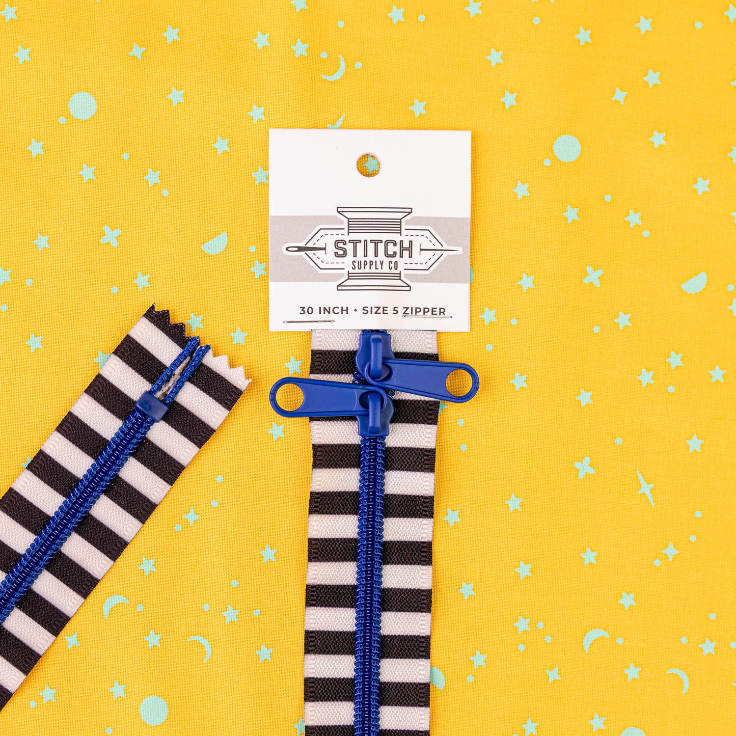 30" Double Zipper on Black and White with Blue Ribbon